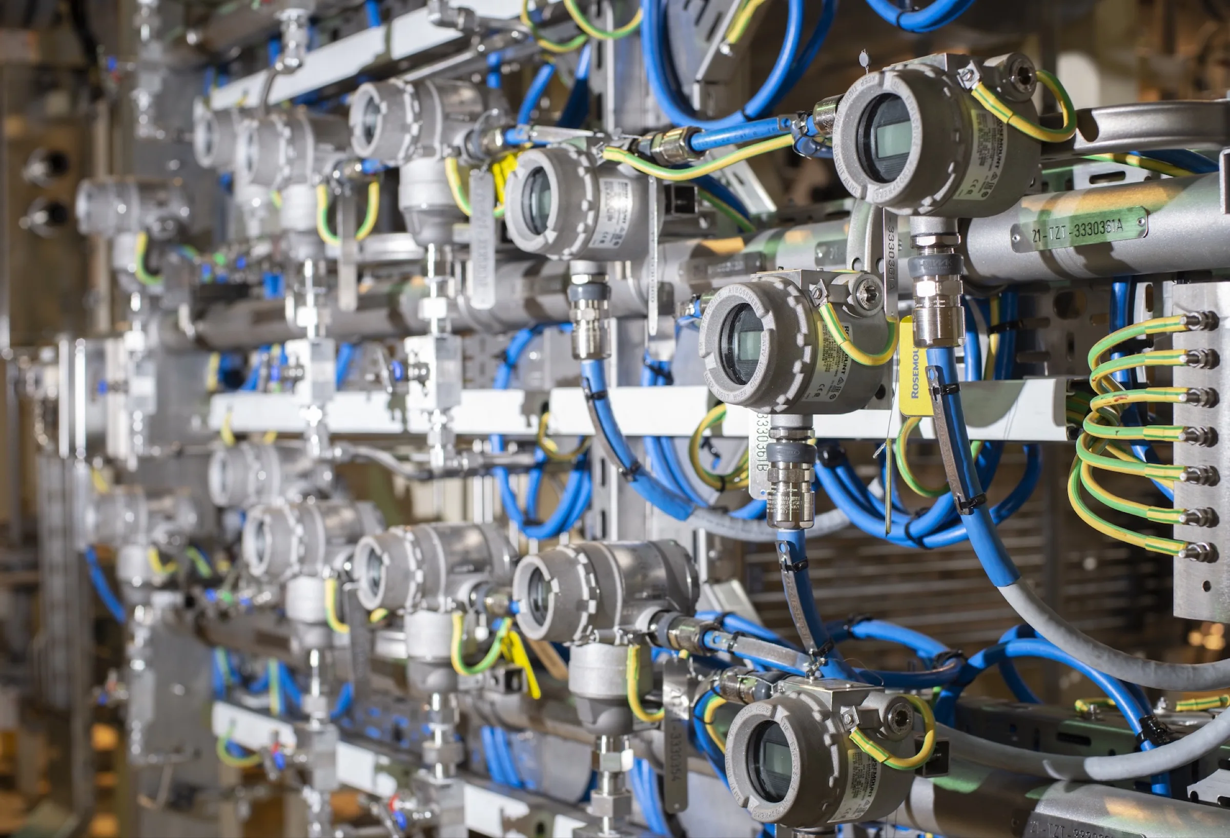 Rack of Rosemount pressure transmitters wired into an instrumentation panel